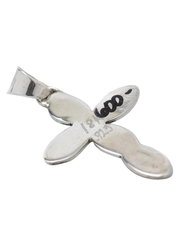 Back side if silver cross pendant showing price written in sharpie