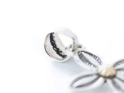 Close up in artist hallmark with the rest of the jewelry blurred out 