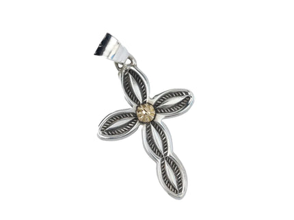 Silver stamped cross pendant with gold in middle on a light gray background