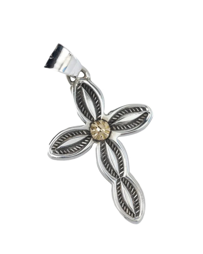 Silver stamped cross pendant with gold in middle on a light gray background