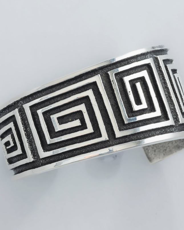 Navajo Cuff bracelet with square geometric pattern on a light gray background