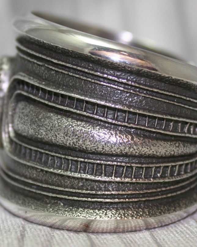 A bold sand-cast cuff featuring intricate textures and patterns, Side Profile, 