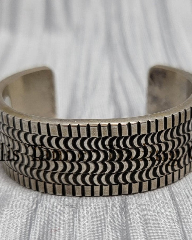 heavy silver, Bracelet features intricate stamped detailing for a unique and stylish look. Displayed on a soft silver cloth, 