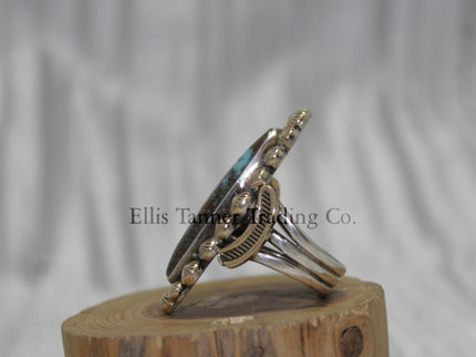 Ring by Tommy Jackson 14k overlay with Bisbee turquoise on wooden display 