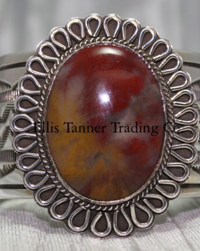 Large silver stamped cuff, with a center Agate stone surrounded with a rope and half round small cut out petals,