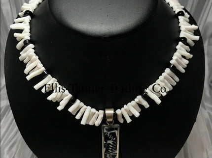 White coral choker with black onyx beads, in the center is a rectangular silver inlayed onyx and white coral pendant. 